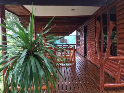 a porch of a wooden house with a plant at Banhalawee in Ko Yao Yai