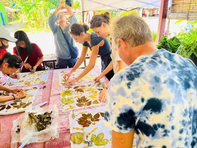 a group of people standing around a table with food at Banhalawee in Ko Yao Yai