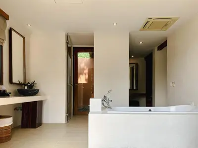 a white bathroom with a tub and a sink at Korsiri Pool Villas in Panwa Beach