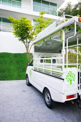 a white camper van parked in front of a building at Peaceful Bliss in 81sqm Top Floor in Kamala in Kamala Beach