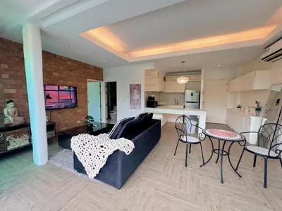 a living room with a couch and a table at Peaceful Bliss in 81sqm Top Floor in Kamala in Kamala Beach
