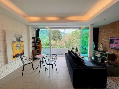 a living room with a couch and a table and chairs at Peaceful Bliss in 81sqm Top Floor in Kamala in Kamala Beach