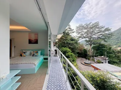 a room with a bed and a balcony with a view at Peaceful Bliss in 81sqm Top Floor in Kamala in Kamala Beach