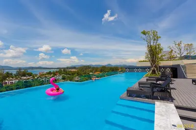 a large swimming pool with a pink inflatable raft at The Aristo Beach by Holy Cow, studio, without kitchen, construction view in Surin Beach