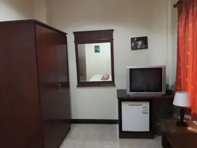 a living room with a television and a mirror at Southern Fried Rice in Kata Beach