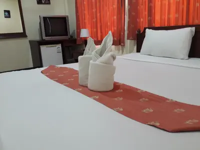 a hotel room with two beds with towels on the bed at Southern Fried Rice in Kata Beach