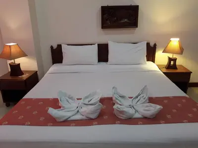 a bed with two pairs of shoes sitting on it at Southern Fried Rice in Kata Beach