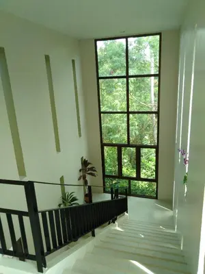 a hallway with a large window and a staircase at C-VIEW BOUTIQUE in Rawai Beach