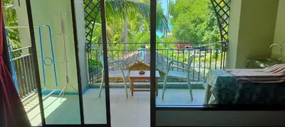 a room with a view of a balcony at C-VIEW BOUTIQUE in Rawai Beach