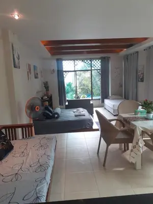 a living room with a bed and a table at C-VIEW BOUTIQUE in Rawai Beach