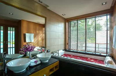 a bathroom with two sinks and a large mirror at Villa Tantawan Resort - Private Pool Villas in Kamala Beach