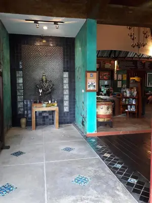 a room with a table and a tile wall at Cocoville Phuket - SHA Plus in Chalong