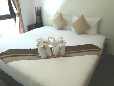 two stuffed animals sitting on top of a bed at Cocoville Phuket - SHA Plus in Chalong