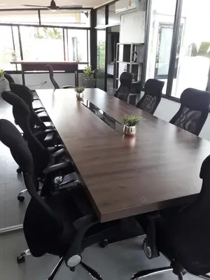 a conference room with a large wooden table and chairs at Cocoville Phuket - SHA Plus in Chalong