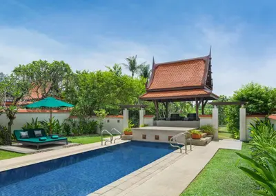 a pool with a gazebo next to a house at Banyan Tree Phuket in Bang Tao Beach
