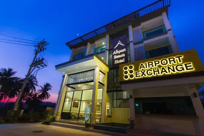 a building with a sign that reads airport exchange at Airport Beach Hotel Phuket in Nai Yang Beach