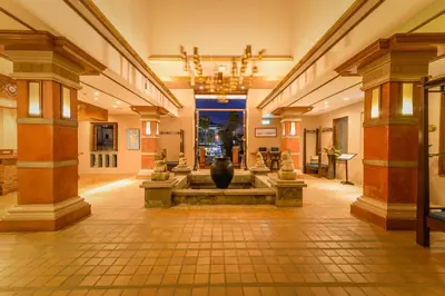 a lobby with a fountain in the middle of a building at Phuket Kata Resotel in Kata Beach