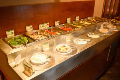 a buffet line with a bunch of food on at Phuket Kata Resotel in Kata Beach