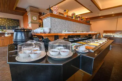 a buffet line with plates and bowls of food at Phuket Kata Resotel in Kata Beach