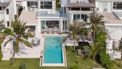an aerial view of a house with a swimming pool and palm trees at Coastal Escape Natai Beach in Natai Beach