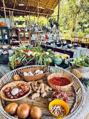 a table with baskets of vegetables on it at Phuket Nonnita Boutique Resort - SHA Plus in Phuket Town