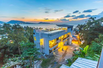 an aerial view of a building in the middle of trees at Rossarin Sea View Patong in Patong Beach