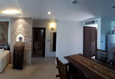 a living room with a couch and a refrigerator at Karon Beach Apartment Sea View in Karon Beach