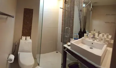 a bathroom with a toilet and a sink and a shower at Karon Beach Apartment Sea View in Karon Beach
