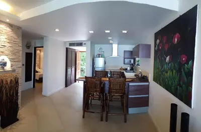 a kitchen with a table and chairs in a room at Karon Beach Apartment Sea View in Karon Beach