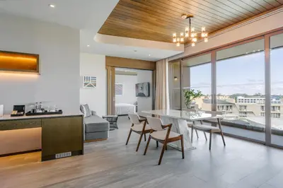 a kitchen and living room with a table and chairs at Metadee Concept Hotel in Kata Beach