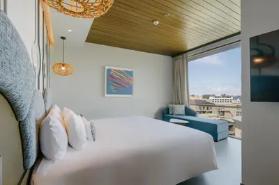 a bedroom with a large white bed and a window at Metadee Concept Hotel in Kata Beach