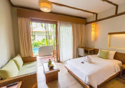 a bedroom with a large bed and a large window at Metadee Concept Hotel in Kata Beach