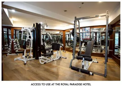 a gym with several tread machines in a room at The Corner in Patong Beach