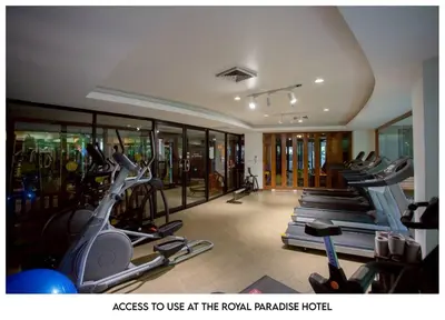 a gym with a row of treadmills and exercise bikes at The Corner in Patong Beach