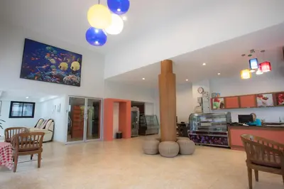 a large living room with a table and chairs at The Corner in Patong Beach