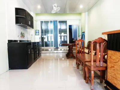 a kitchen and dining room with a table and chairs at One One Hostel Patong in Patong Beach