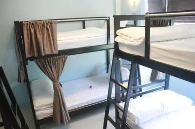 a group of bunk beds in a room at One One Hostel Patong in Patong Beach