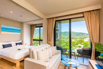 a bedroom with a bed and a living room at Diamond Resort Phuket Official Account in Bang Tao Beach