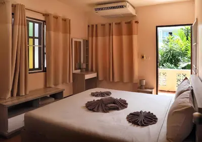 a bedroom with a bed with brown blankets on it at Villa Kamala Beach in Kamala Beach