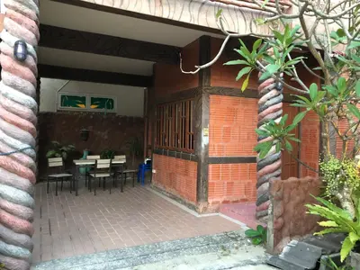 an external view of a patio with tables and chairs at Villa Kamala Beach in Kamala Beach