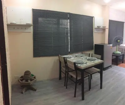 a table and chairs in a kitchen with a window at Villa Kamala Beach in Kamala Beach