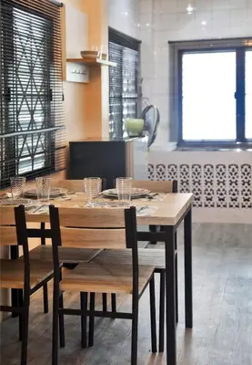 a wooden table and chairs in a kitchen at Villa Kamala Beach in Kamala Beach