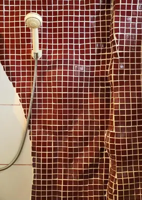 a shower curtain in a bathroom with a shower head at Villa Kamala Beach in Kamala Beach