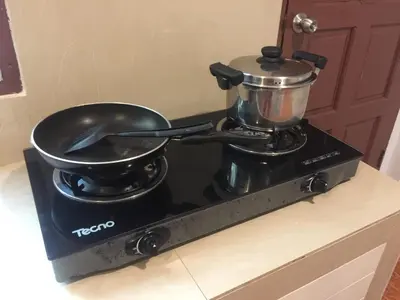 a pot and a pan on a stove at Surin House in Surin Beach