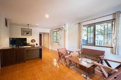 a living room with a couch and a table at Surin House in Surin Beach
