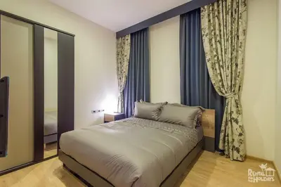 a bedroom with a large bed in front of a window at Baan Mai Khao Condominium in Mai Khao Beach