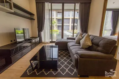 a living room with a couch and a tv at Baan Mai Khao Condominium in Mai Khao Beach