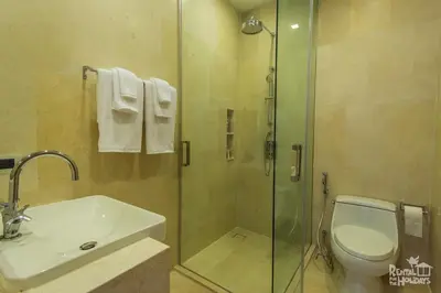 a bathroom with a shower and a toilet and a sink at Baan Mai Khao Condominium in Mai Khao Beach