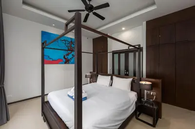a bedroom with a four poster bed with a ceiling fan at VILLA ARU Private Pool 3 min to Naiharn Beach in Nai Harn Beach