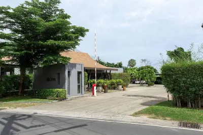 a building with a red fire hydrant next to a street at VILLA ARU Private Pool 3 min to Naiharn Beach in Nai Harn Beach
